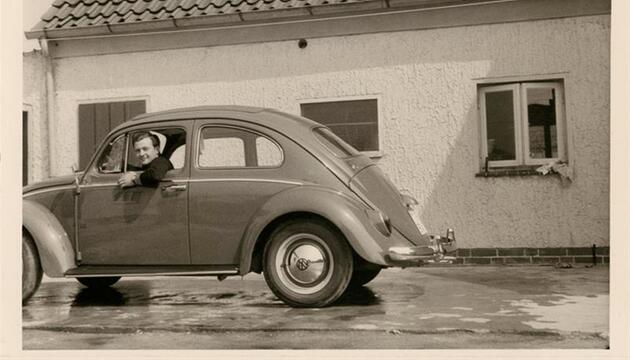 Ein Mann in einem VW Käfer 