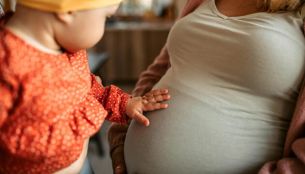 Schwangere Frau mit kleinem Kind