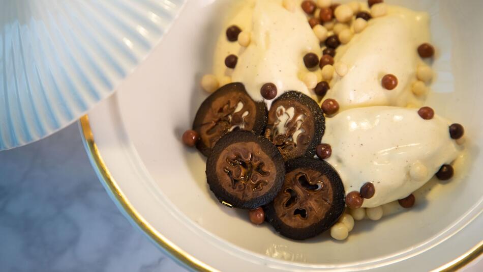 Schwarze Walnüsse auf Vanilleeis mit Schokoladenkugeln
