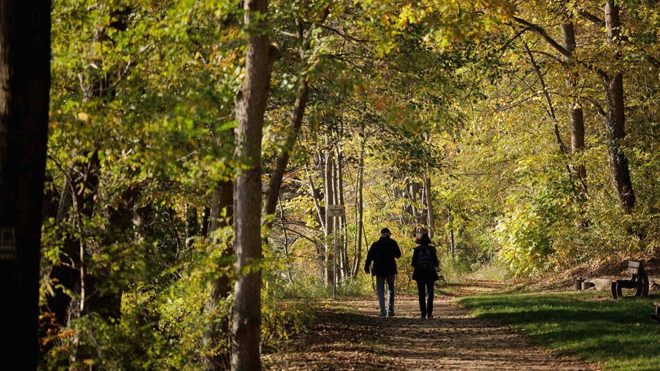 Passanten gehen bei strahlender Herbstsonne spazieren