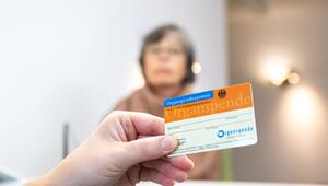 Person hält in einer Arztpraxis einen Organspendeausweis