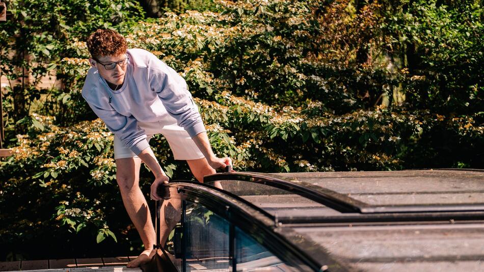 Ein junger Mann deckt einen Pool ab
