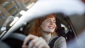 Eine Frau sitzt am Steuer eines Autos.