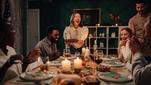 Lachende Freunde sitzen am Abendbrottisch 