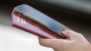 Frau hält Reisepass und Smartphone in der Hand