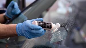 Ein Steinschlagschaden in der Frontscheibe wird repariert