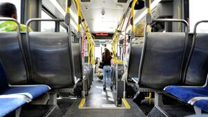 Innenraum eines Busses mit blauen Sitzpolstern und schwarzen Rückenlehnen. Gelbe Haltestangen ...