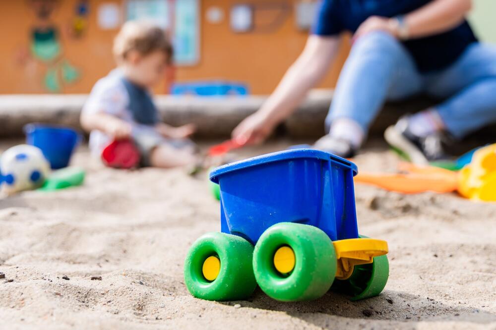 Ein Kind spielt im Sandkasten