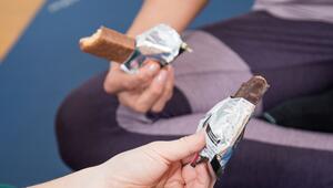 Zwei Personen halten Schokoriegel in den Händen