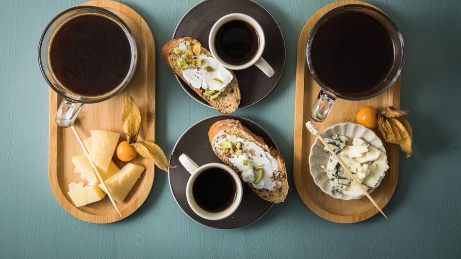 Tabletts mit Kaffee, Espresso und verschiedenem Käse