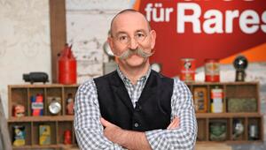 Horst Lichter vor einem Regal und dem "Bares für Rares"-Logo.