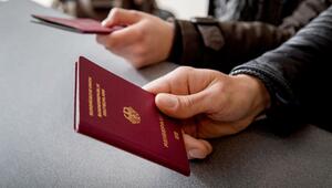Mann hält einen Reisepass in der Hand