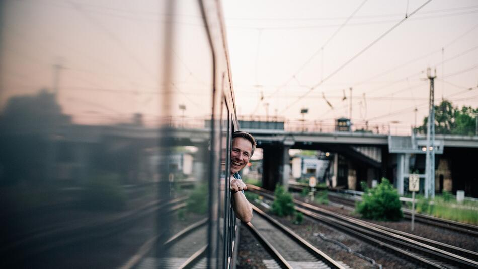 Ein Mann schaut aus einem Zugfenster