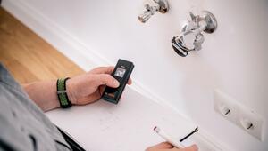 Küchenplaner nimmt Aufmaß mit Laser-Entfernungsmessgerät